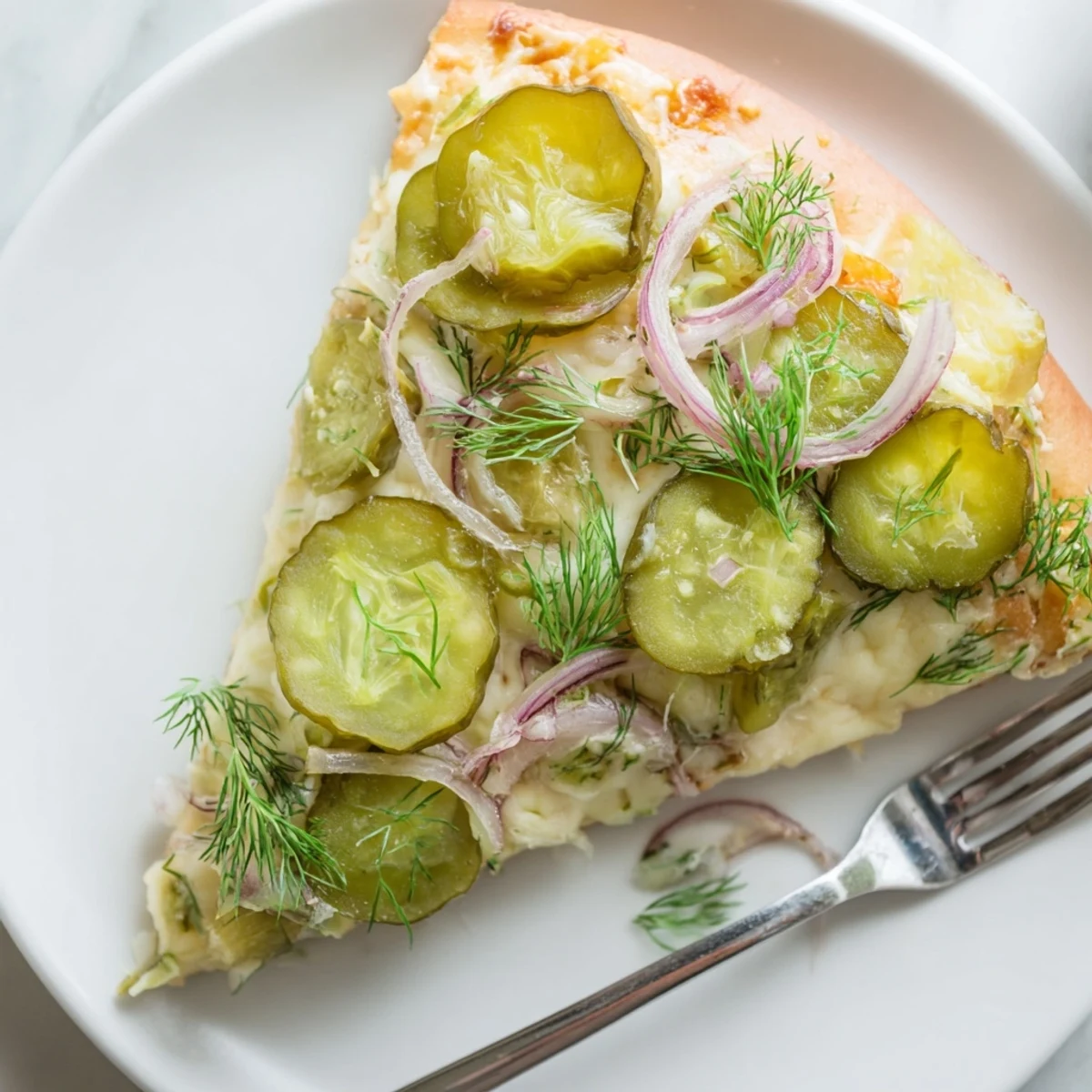 Enjoy a cheesy Pickle Pizza bursting with dill tang and rich crème fraîche goodness.