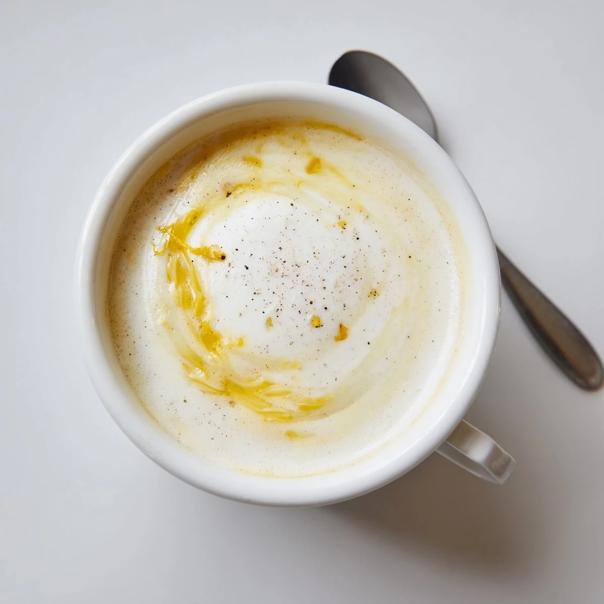 A creamy Onion Latte topped with frothed milk and savory caramelized onions.  