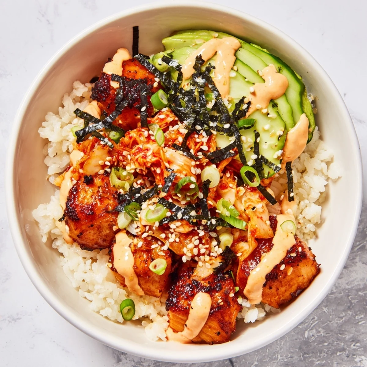 Savory crispy salmon rice bowl featuring fluffy rice, tangy kimchi, and garlic crunch.