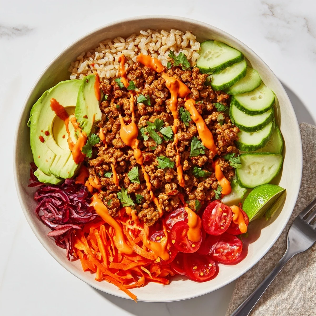 Healthy plant-based meat bowl featuring vibrant vegetables and creamy spicy mayo drizzle.