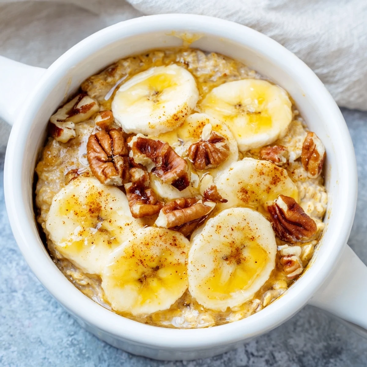 These Baked Oats Ramekins glisten with honey, showing a warm, bubbly texture, perfect for a cozy morning.