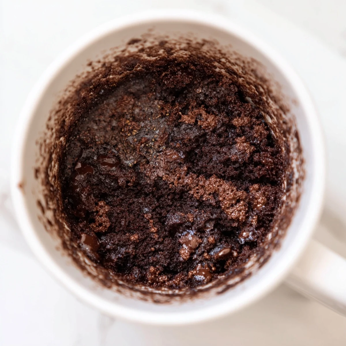 Steaming, fluffy microwaved mug cake, perfect for a fast dessert craving, ready to eat now!