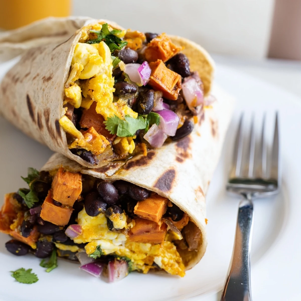 Perfectly wrapped sweet potato and black bean breakfast burritos, ready to be enjoyed with salsa.