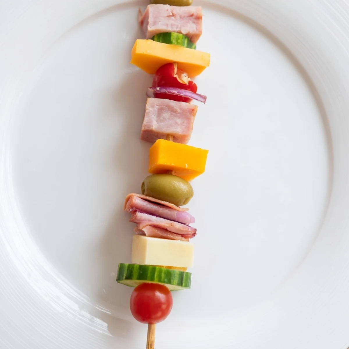 Freshly made Savory Skewers present a delicious mix of turkey, Swiss cheese, and cherry tomatoes.
