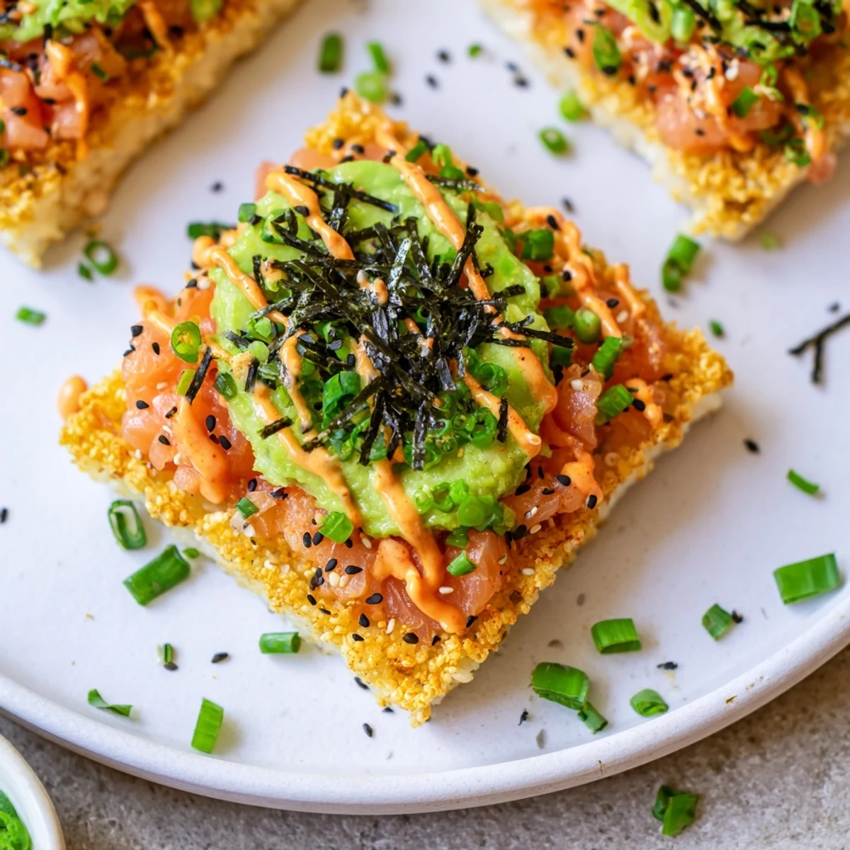 Golden, crispy rice forms the base of this Crispy Rice Salmon Stack topped with fresh salmon.