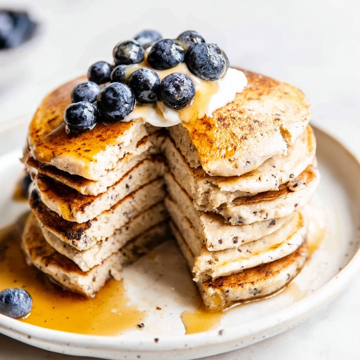 Warm cottage cheese pancakes, a perfect breakfast, are being flipped on a hot griddle.