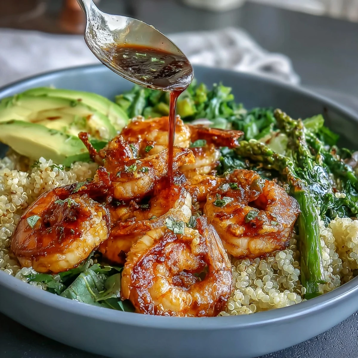 Flavorful Detox Buddha Bowl featuring tender shrimp, quinoa, and crisp vegetables drizzled.