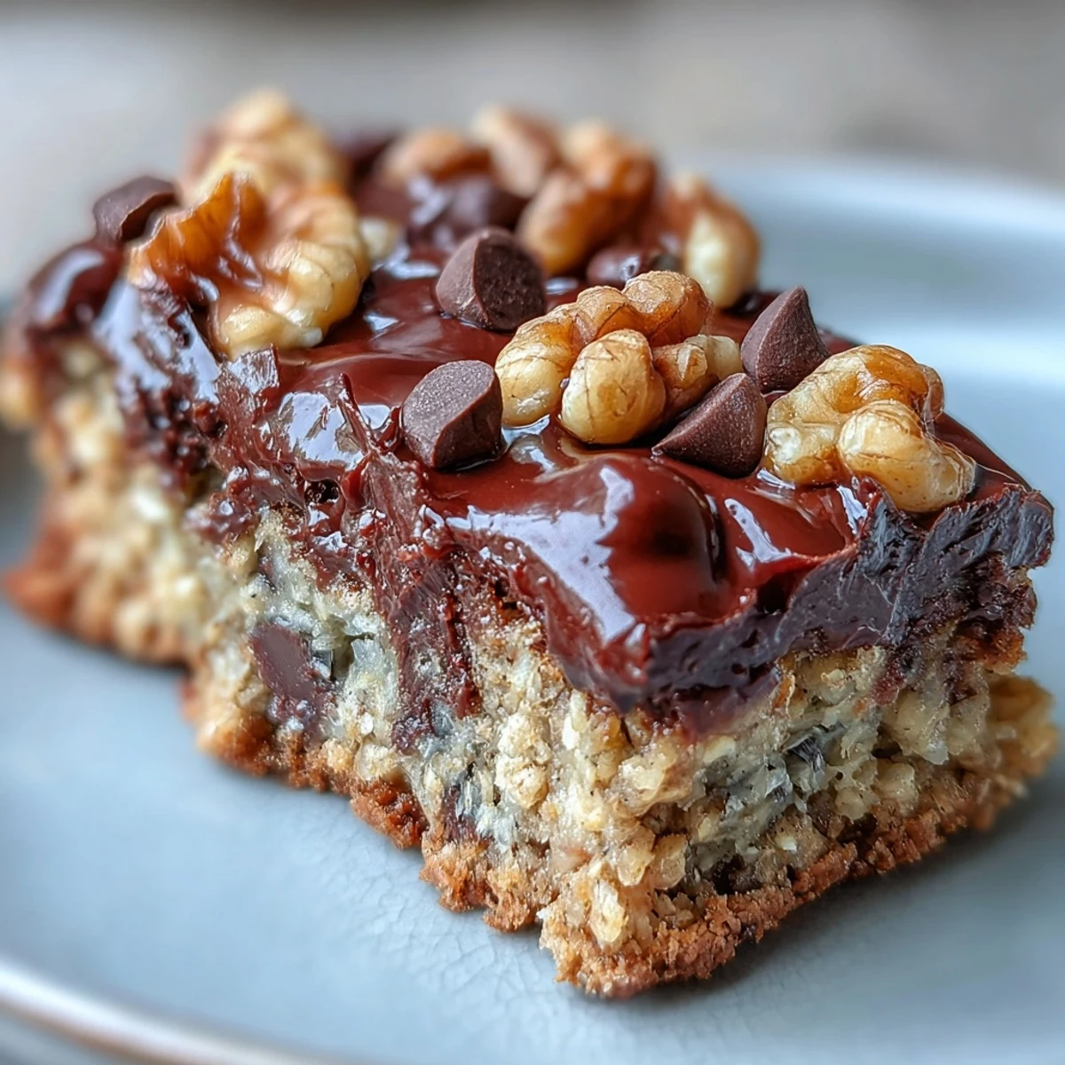 Sliced Chunky Monkey Protein Baked Oat Bars on a wooden board with bananas nearby.