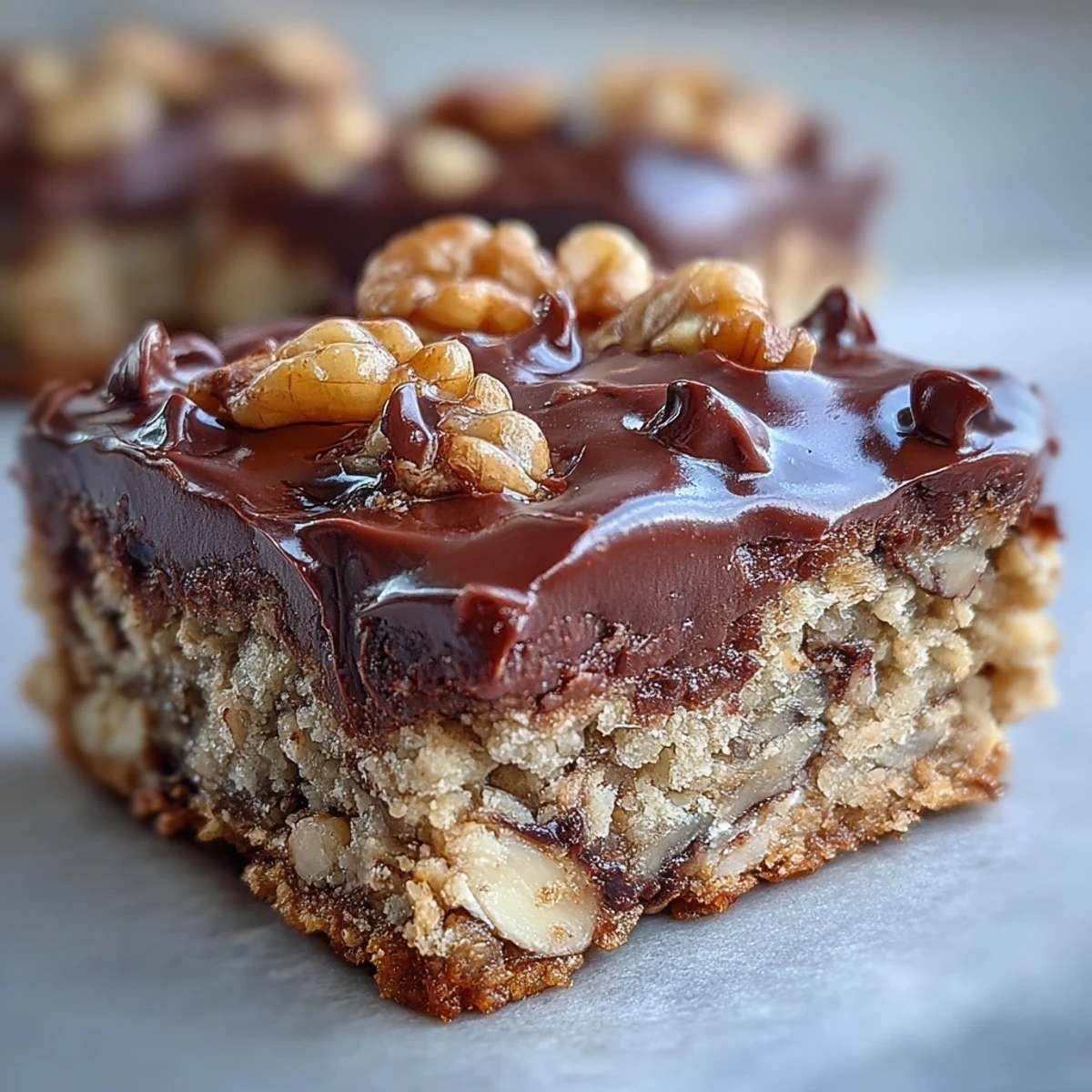 Golden, grab-and-go Chunky Monkey Protein Baked Oat Bars served with a glass of almond milk.