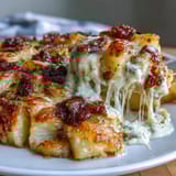 A bubbling casserole of cheesy scalloped potatoes, golden and gooey, perfect for family dinners.