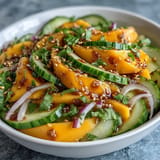 Tangy and spicy mango cucumber Tajín ribbon salad, perfect summer side dish.