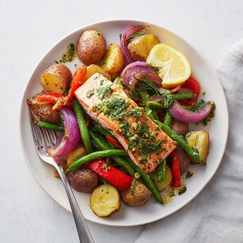 Tender Lemon Herb Salmon & Potato Sheet Pan with crispy veggies and zesty flavors.  