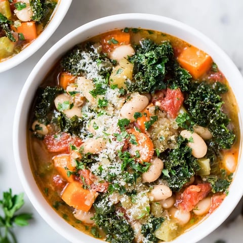 Steaming Italian Bean & Kale Stew, a vibrant, flavorful Italian vegetarian stew, is served hot in a bowl.