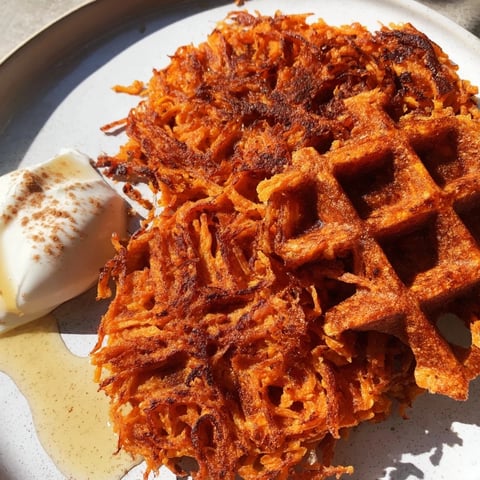 Golden, crispy sweet potato waffles, perfect for a healthy breakfast or quick snack, served warm.