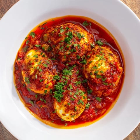 Savory Baked Eggs in Tomato Sauce: a vibrant, bubbling skillet of eggs, tomatoes, and peppers, ready to serve.