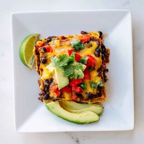 Quick Black Bean and Corn Tortilla Casserole bubbling hot with melted cheese, ready for serving tonight.