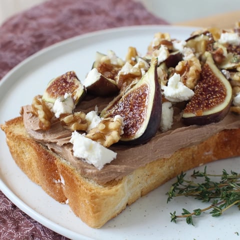 Royal Tapestry appetizer with layered pâté, figs, goat cheese, and walnuts for a delicious bite.