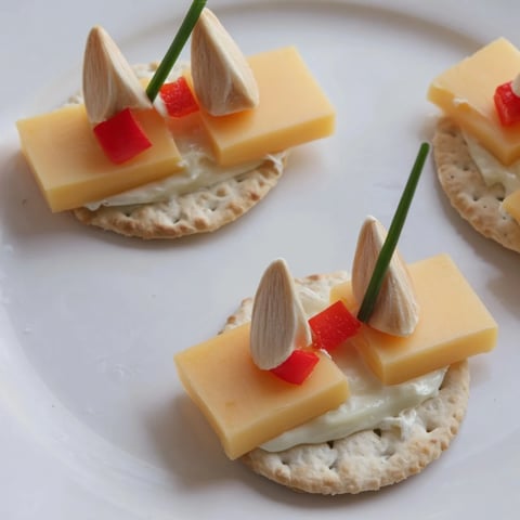 Adorable, bite-sized Alpine Village appetizer featuring cheese houses with almond roofs, so festive!