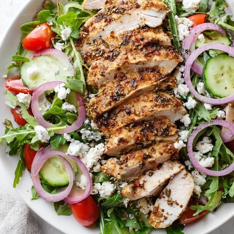 Quick Pan-Seared Chicken Salad with golden chicken slices over fresh greens, drizzled with balsamic dressing.