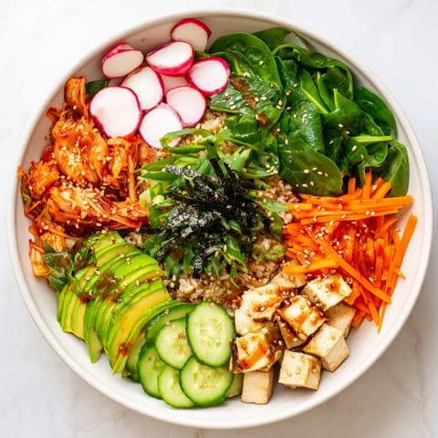 Colorful Fermented Vegetable Bowl featuring tangy kimchi, nutritious grains, and creamy avocado slices.  
