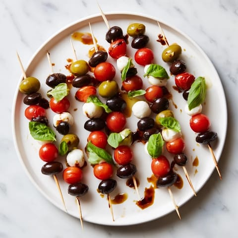 Festive Christmas Lights Olive and Tomato Skewers, a delicious vegetarian appetizer ready for your holiday celebrations.