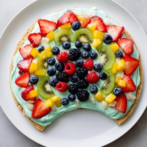 Cool, frosted Under the Sea Mermaid Tail Fruit Pizza with juicy, layered fruit offering a sweet, summery flavor.