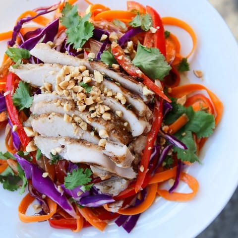 Fresh Carrot Ribbon and Chicken Slaw tossed with a vibrant ginger-miso dressing, ready to enjoy.