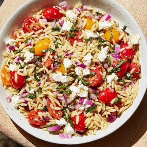 Close-up of fresh Tomato Feta Orzo, a colorful Mediterranean dish perfect for summer meals.