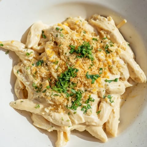 Golden-topped high-protein mac & cheese with melted cheese promises a comforting, cheesy bite.