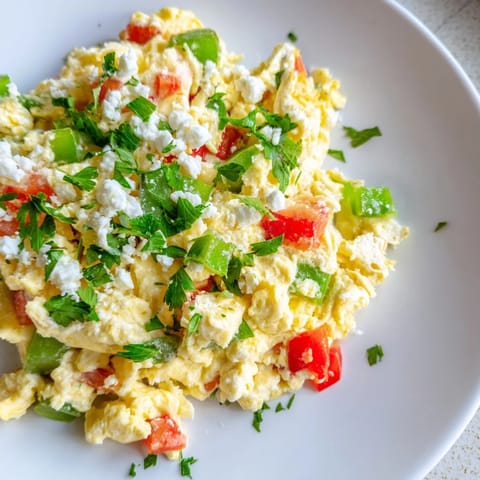 Golden and creamy Turkish Menemen Scramble served with crusty bread, a delicious vegetarian breakfast.