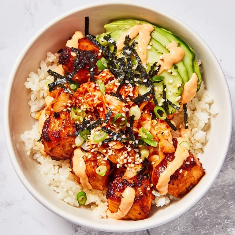 Savory crispy salmon rice bowl featuring fluffy rice, tangy kimchi, and garlic crunch.