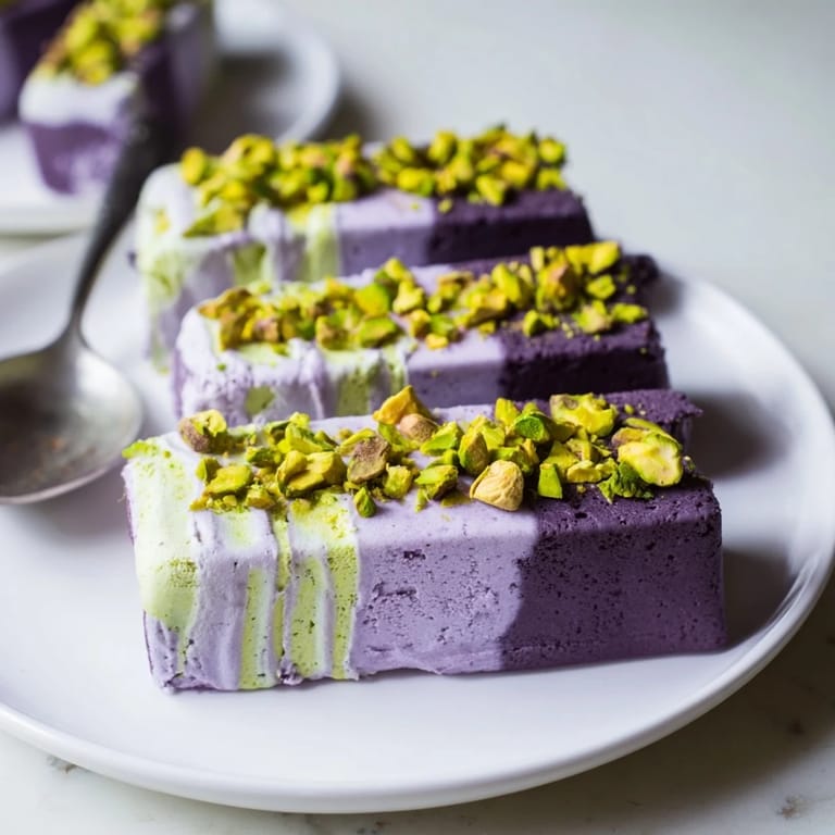 Vibrant ice cream bars showcasing rich ube and crunchy pistachio flavors, perfect for summer.