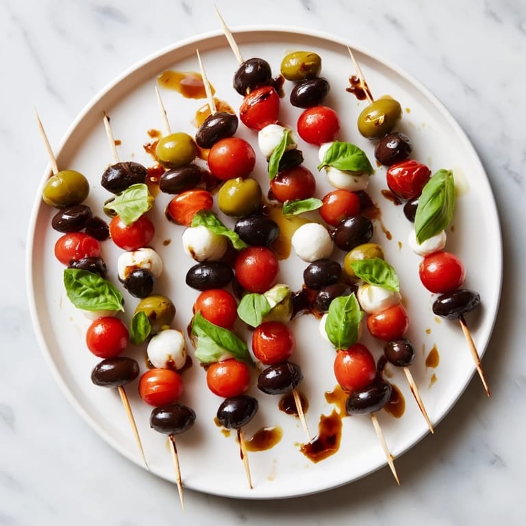 Festive Christmas Lights Olive and Tomato Skewers, a delicious vegetarian appetizer ready for your holiday celebrations.