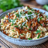 Tender orzo pasta dish with deeply caramelized onions, fresh parsley, and parmesan.